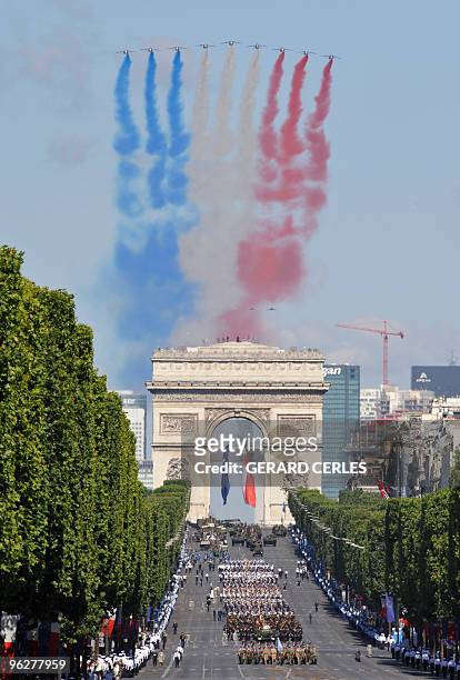 French air force Alpha Jets flyes over the Arc de Triomphe during the ceremony of the Bastille Day, 14 July 2008 in Paris. France kicked off Bastille...