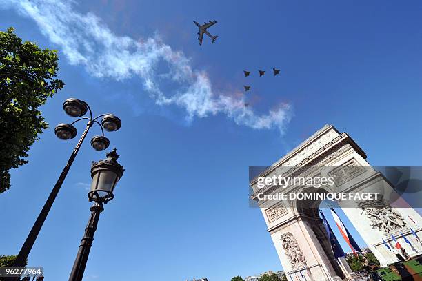 French refueling tanker followed by French and Italian and French air force planes flies over the Arc de Triomphe during the ceremony of the Bastille...