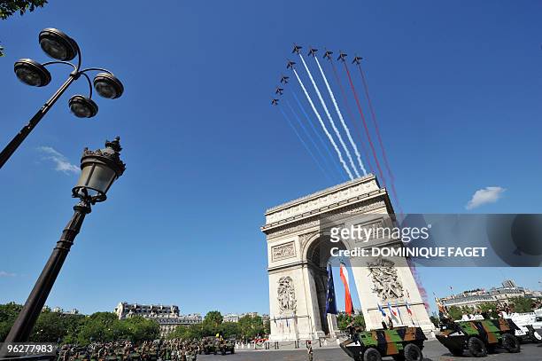 French air force Alpha Jets fly over the Arc de Triomphe during the ceremony of the Bastille Day, 14 July 2008 in Paris. France kicked off Bastille...