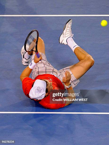 Tennis player Bob Bryan falls on the court during his men's doubles final match with partner Mike Bryan against Daniel Nestor of Canada and Nenad...