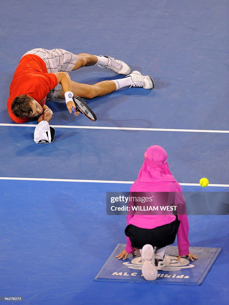 US tennis player Bob Bryan (L) falls on