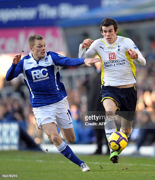 Birmingham City's Swedish midfielder Sebastian Larsson vies with Tottenham Hotspur's Welsh defender Gareth Bale during the English Premier League...