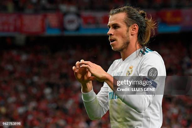Real Madrid's Welsh forward Gareth Bale celebrates after scoring his second goal during the UEFA Champions League final football match between...