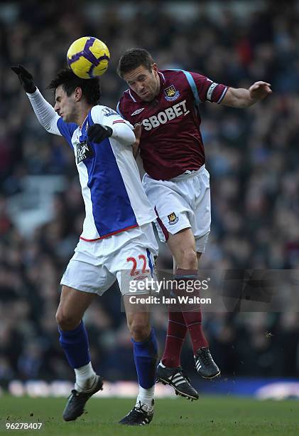 Matthew Upson of West Ham United jumps for a header with Nikola Kalinic of Blackburn Rovers during the Barclays Premier League match between West Ham...