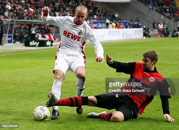 Miso Brecko of Koeln is challenged by Marco Russ of Frankfurt during the Bundesliga match between Eintracht Frankfurt and 1. FC Koeln at the...