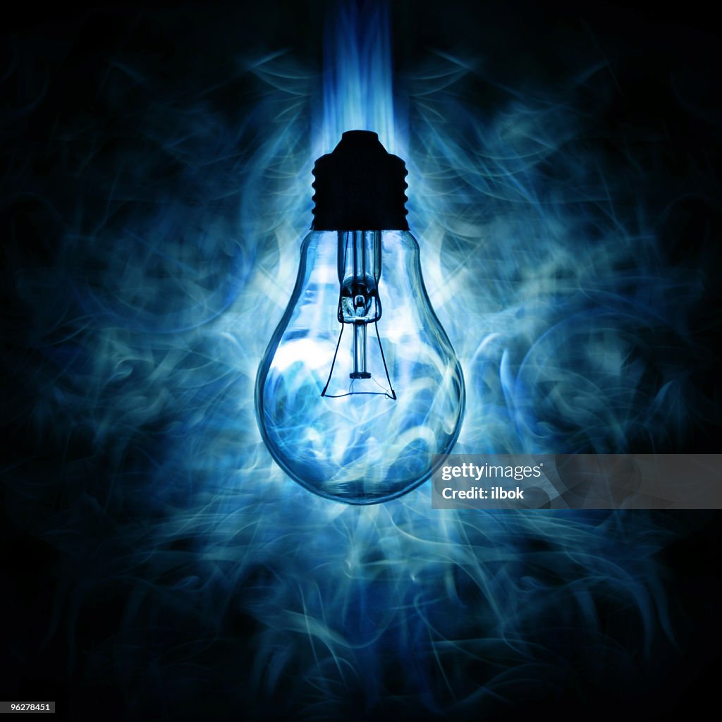 Light bulb and blue smoky light background