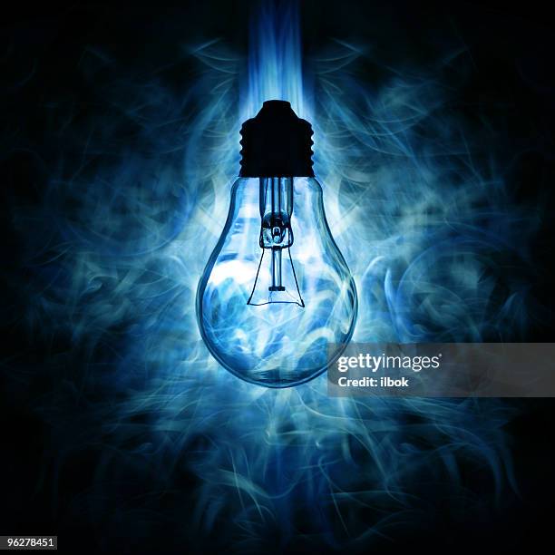 light bulb and blue smoky light background - spark creativity stock pictures, royalty-free photos & images