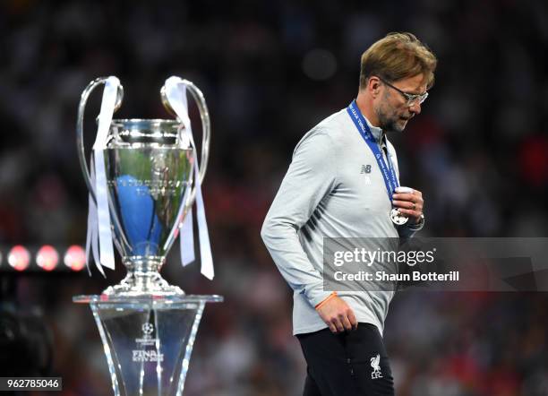 Jurgen Klopp, Manager of Liverpool walks past the UEFA Champions League trophy following the UEFA Champions League Final between Real Madrid and...
