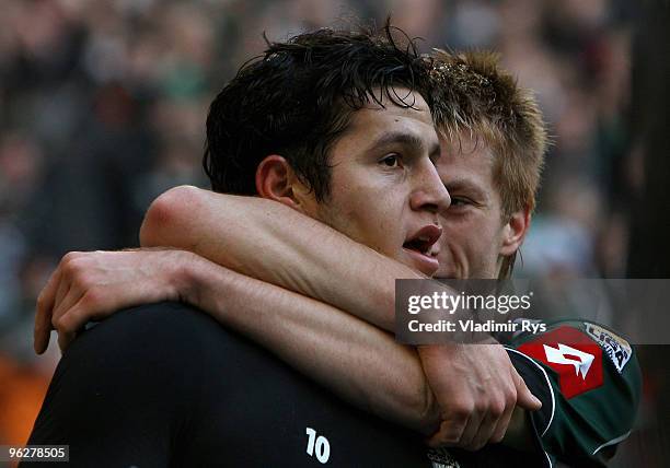 Raul Bobadilla of Moenchengladbach celebrates with his team mate Marco Reus after scoring his team's fourth goal during the Bundesliga match between...