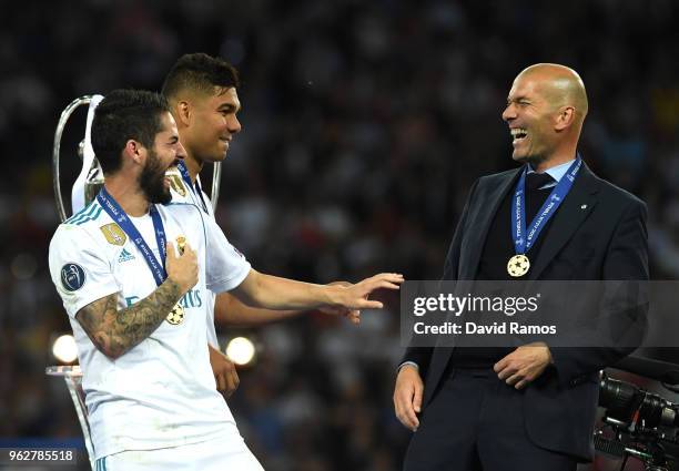 Isco of Real Madrid speaks with Zinedine Zidane, Manager of Real Madrid following their sides victory in the UEFA Champions League Final between Real...