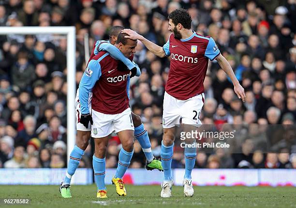 Gabriel Agbonlahor of Aston Villa is congratulated by treammates Ashley Young and Carlos Cuellar after scoring the opening goal during the Barclays...