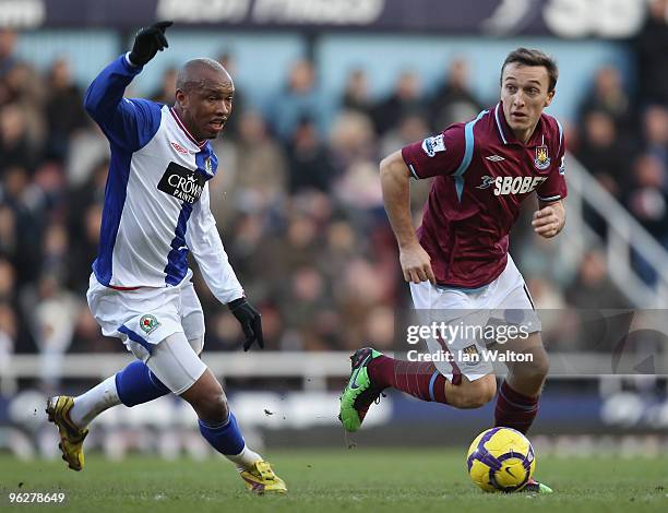 Mark Noble of West Ham United skips away from El Hadji Diouf of Blackburn Rovers during the Barclays Premier League match between West Ham United and...