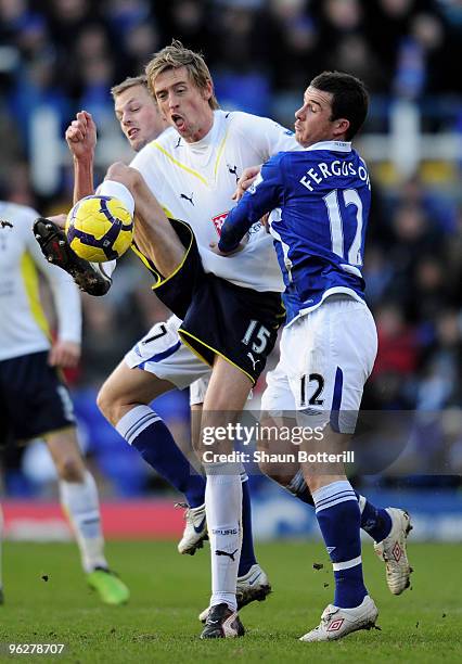 Peter Crouch of Tottenham Hotspur is challenged by Barry Ferguson of Birmingham City during the Barclays Premier League match between Birmingham City...