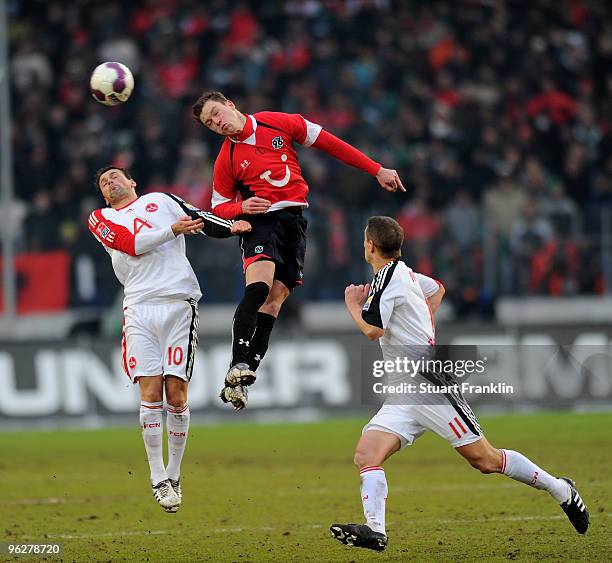 Arnold Bruggink of Hannover challenges Albert Bunjaku of Nuernberg during the Bundesliga match between Hannover 96 and FC Nuernberg at AWD-Arena on...