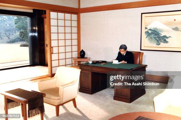 Emperor Akihito reads a document to approve the name of new era 'Heisei' after Emperor Hirohito died of cancer on January 7, 1989 in Tokyo, Japan.