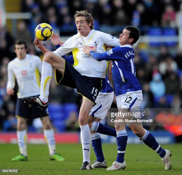 Peter Crouch of Tottenham Hotspur is challenged by Barry Ferguson of Birmingham City during the Barclays Premier League match between Birmingham City...