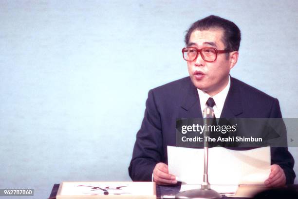 Chief Cabinet Secretary Keizo Obuchi announces the new era name 'Heisei' during a press conference after Emperor Hirohito died of cancer at the prime...