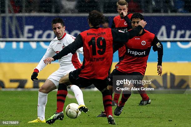 Zoran Tosic of Koeln is challenged by Halil Altintop of Frankfurt during the Bundesliga match between Eintracht Frankfurt and 1. FC Koeln at the...