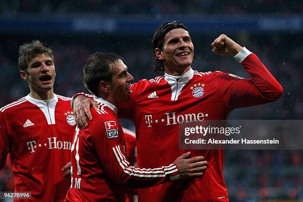 Mario Gomez of Muenchen celebrates scoring the second team goal with his team mates Philipp Lahm and Thomas Mueller during the Bundesliga match...