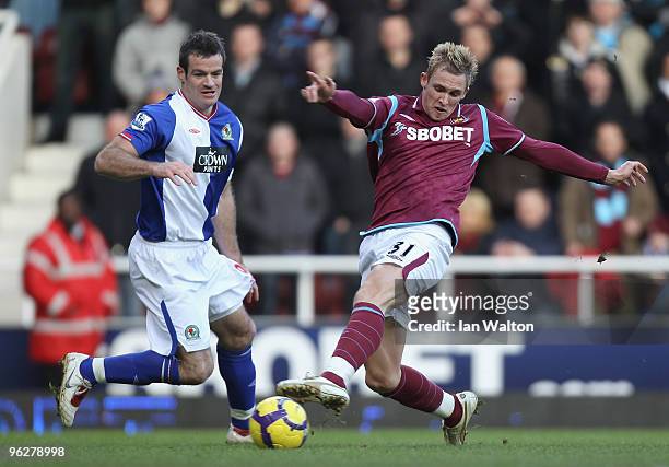 Jack Collison of West Ham United shoots at goal under pressure from Ryan Nelsen of Blackburn Rovers during the Barclays Premier League match between...