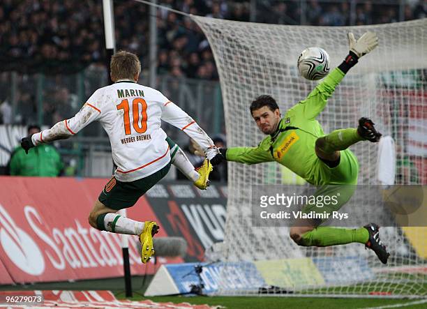 Logan Bailly of Moenchengladbach tries to block a shot from Marko Marin of Bremen during the Bundesliga match between Borussia Moenchengladbach and...