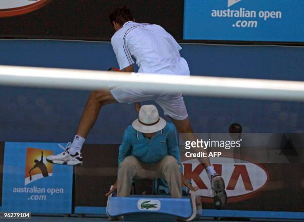 Croatian tennis player Marin Cilic vaults over a lines official during his men's singles quarter-final match against US opponent Andy Roddick on day...