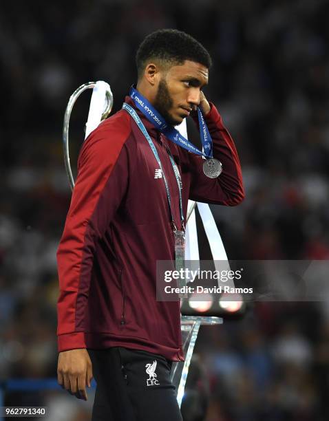 Joe Gomez of Liverpool recieves his runners up medal following his sides defeat in the UEFA Champions League Final between Real Madrid and Liverpool...