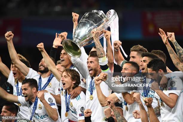 Real Madrid's players celebrate with the trophy after winning the UEFA Champions League final football match between Liverpool and Real Madrid at the...