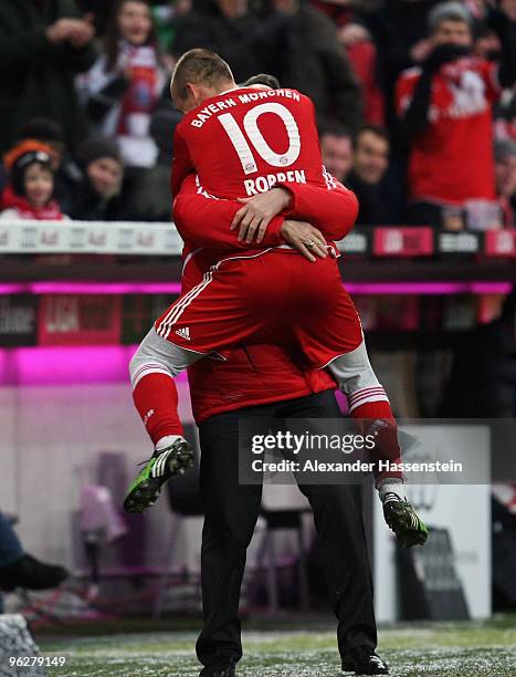 Arjen Robben of Muenchen celebrates scoring the 3rd team goal with his head coach Louis van Gaal during the Bundesliga match between FC Bayern...