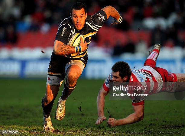 Gloucester centre Tim Molenaar dives in vain to stop Warriors winger Rico Gear during the LV Anglo Welsh Cup match between Gloucester and Worcester...