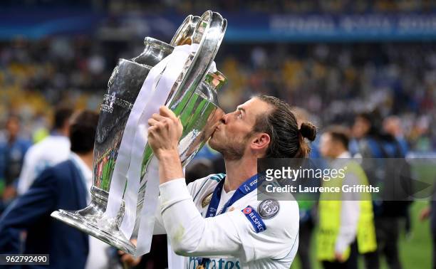 Gareth Bale of Real Madrid kisses the UEFA Champions League Trophy following his sides victory in the UEFA Champions League Final between Real Madrid...