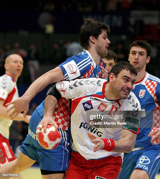 Domagoj Duvnjak of Croatia in action with Bartosz Jurecki of Poland during the Men's Handball European semi final match between Croatia and Poland at...
