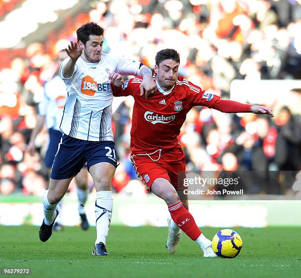 Albert Riera of Liverpool competes with Tamir Cohen of Bolton Wanderers during the Barclays Premier League match between Liverpool and Bolton...