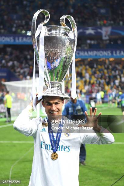 Cristiano Ronaldo of Real Madrid poses with the UEFA Champions League trophy following the UEFA Champions League Final between Real Madrid and...