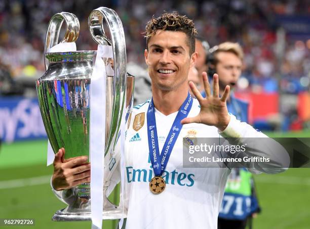 Cristiano Ronaldo of Real Madrid poses with the UEFA Champions League trophy following the UEFA Champions League Final between Real Madrid and...