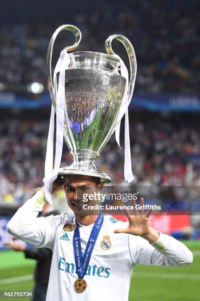 Cristiano Ronaldo of Real Madrid poses with the UEFA Champions League trophy following the UEFA Champions League Final between Real Madrid and...