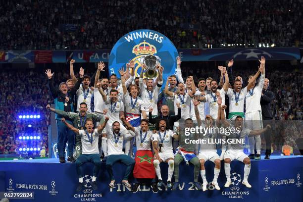 Real Madrid's Spanish defender Sergio Ramos lifts the trophy after winning the UEFA Champions League final football match between Liverpool and Real...