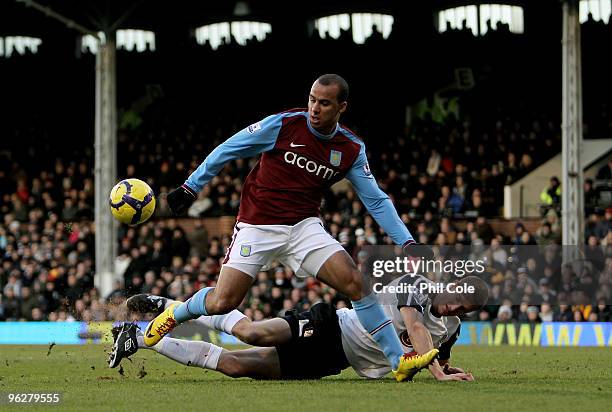 Gabriel Agbonlahor of Aston Villa is tackled by Brede Hangeland of Fulham during the Barclays Premier League match between Fulham and Aston Villa at...