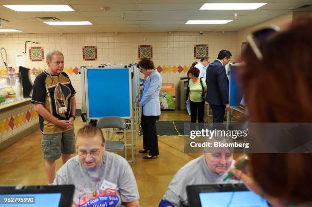 Representative Jacky Rosen, a Democrat from Nevada and Democratic U.S. Senate candidate, center, casts a ballot while early voting at Cardenas...