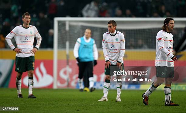Per Mertesacker, Markus Rosenberg and Torsten Frings of Bremen look dejected after losing the Bundesliga match between Borussia Moenchengladbach and...