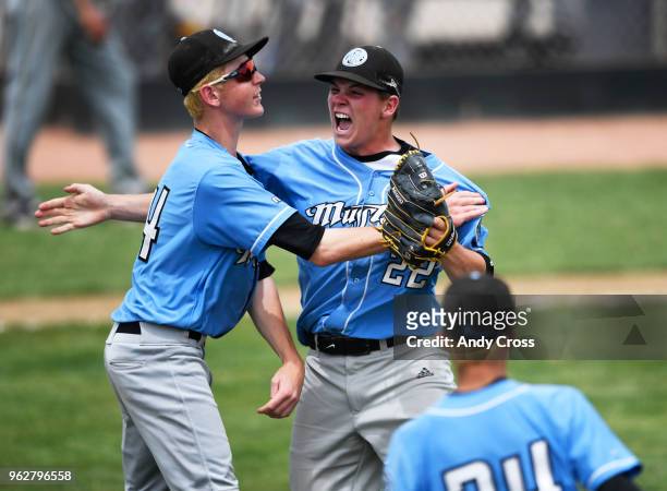 Mountain Range baseball players Mike Polson, #4, left, and Matt Cusack, #34, celebrate with pitcher Brayden Brooks, #22, center, celebrate after...