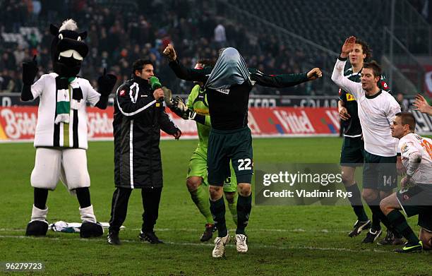 Tobias Levels of Moenchengladbach celebrates with his jersey over his head with his team after winning the Bundesliga match between Borussia...