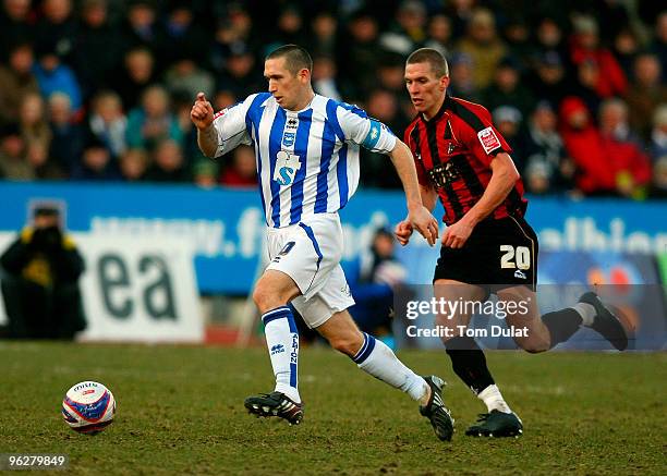 Andrew Crofts of Brighton and Hove Albion and Steve Morison of Millwall chase the ball during the Coca-Cola Division One Championship match between...