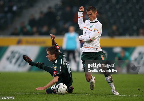 Markus Rosenberg of Bremen and Patrick Herrmann of Moenchengladbach battle for the ball during the Bundesliga match between Borussia Moenchengladbach...