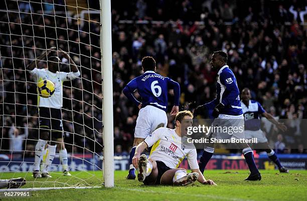 Liam Ridgewell of Birmingham City celebrates as Michael Dawson of Tottenham Hotspur looks dejected during the Barclays Premier League match between...