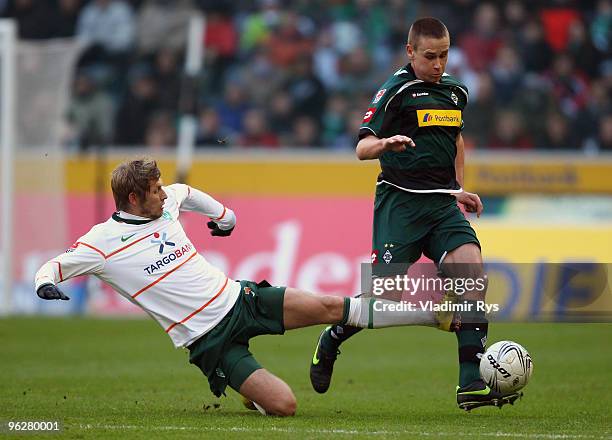 Aaron Hunt of Bremen slides into Filip Daems of Moenchengladbach during the Bundesliga match between Borussia Moenchengladbach and SV Werder Bremen...