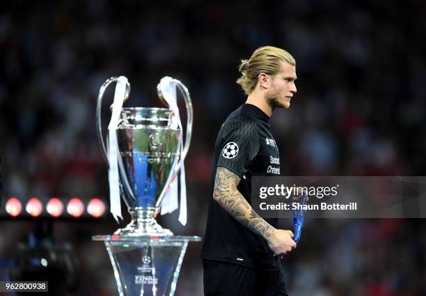 Loris Karius of Liverpool walks past the The UEFA Champions League trophy following his side's loss in the UEFA Champions League Final between Real...