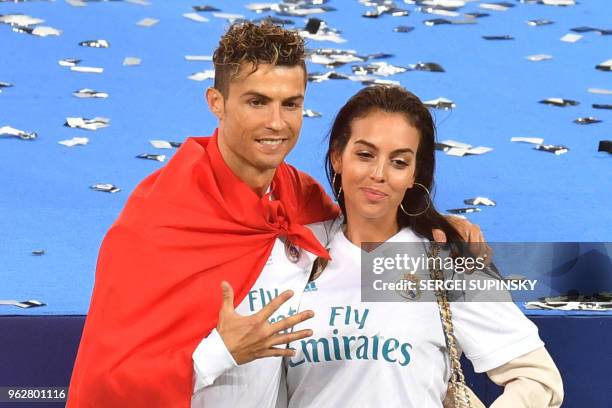 Real Madrid's Portuguese forward Cristiano Ronaldo poses with his girlfriend Georgina Rodriguez after his team won the UEFA Champions League final...