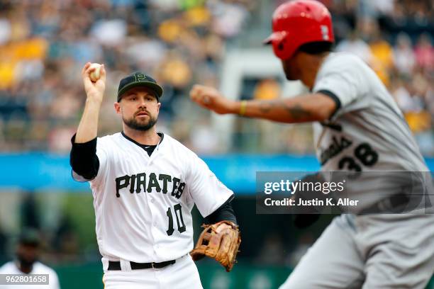 Jordy Mercer of the Pittsburgh Pirates runs down Jose Martinez of the St. Louis Cardinals at PNC Park on May 26, 2018 in Pittsburgh, Pennsylvania.