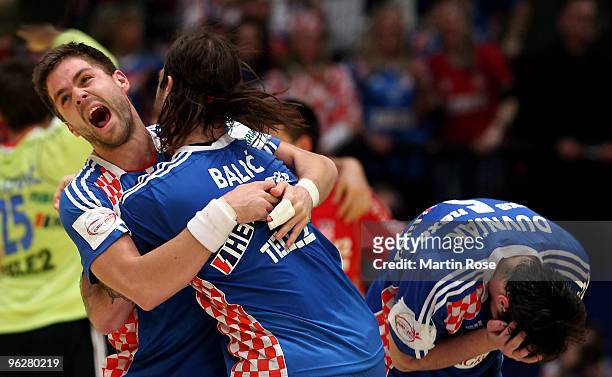 Ivan Cupic of Croatia celebrates with his team mate Ivano Balic after the Men's Handball European semi final match between Croatia and Poland at the...